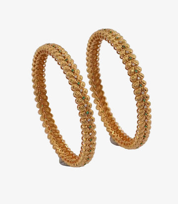 Pair of textured gold bangles with a repeating bead-like pattern, accented by small green and clear stones, displayed on a plain background.