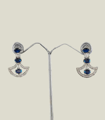 Pair Of Diamond Earrings With Blue Gemstones on a dark background